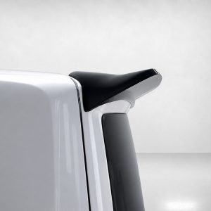 Close-up of a black car spoiler mounted on a silver trunk, elevating the rear edge of the vehicle.