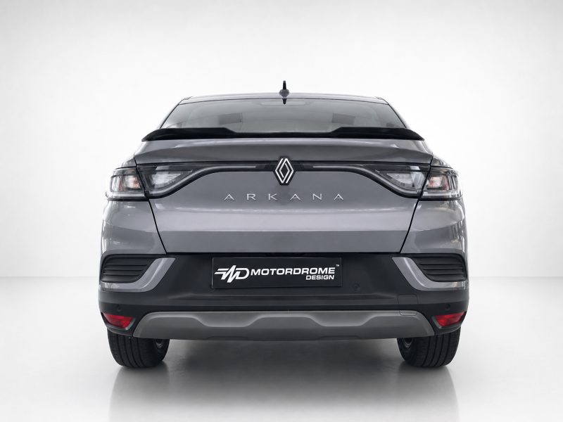 Rear view of a silver Renault Arkana SUV in a studio, with a Motordrome Design plate on the bumper.