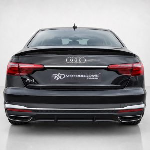 A-556_3jpg - OPSHOLDERS Rear view of a black Audi A4 with Audi rings logo and a Motordrome Design plate on the trunk