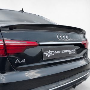 A-556_5jpg - OPSHOLDERS Rear view of a black Audi A4 showing LED taillights and a MotorDrome Design license plate.