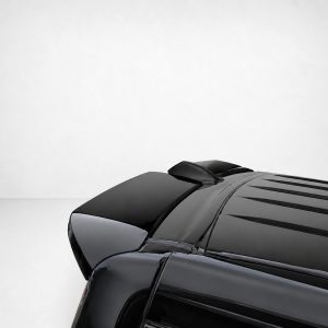 Partial view of a sleek black car, focusing on the glossy hood and roof at the lower-right corner.