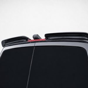 Rear view of a glossy black SUV with raised roof rails and a slim red third brake light between them