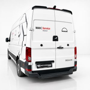 A-561_2jpg - OPSHOLDERS Rear view of a white MAN cargo van with 'MAN Service' branding on the doors and a logo on the right door in a studio setting