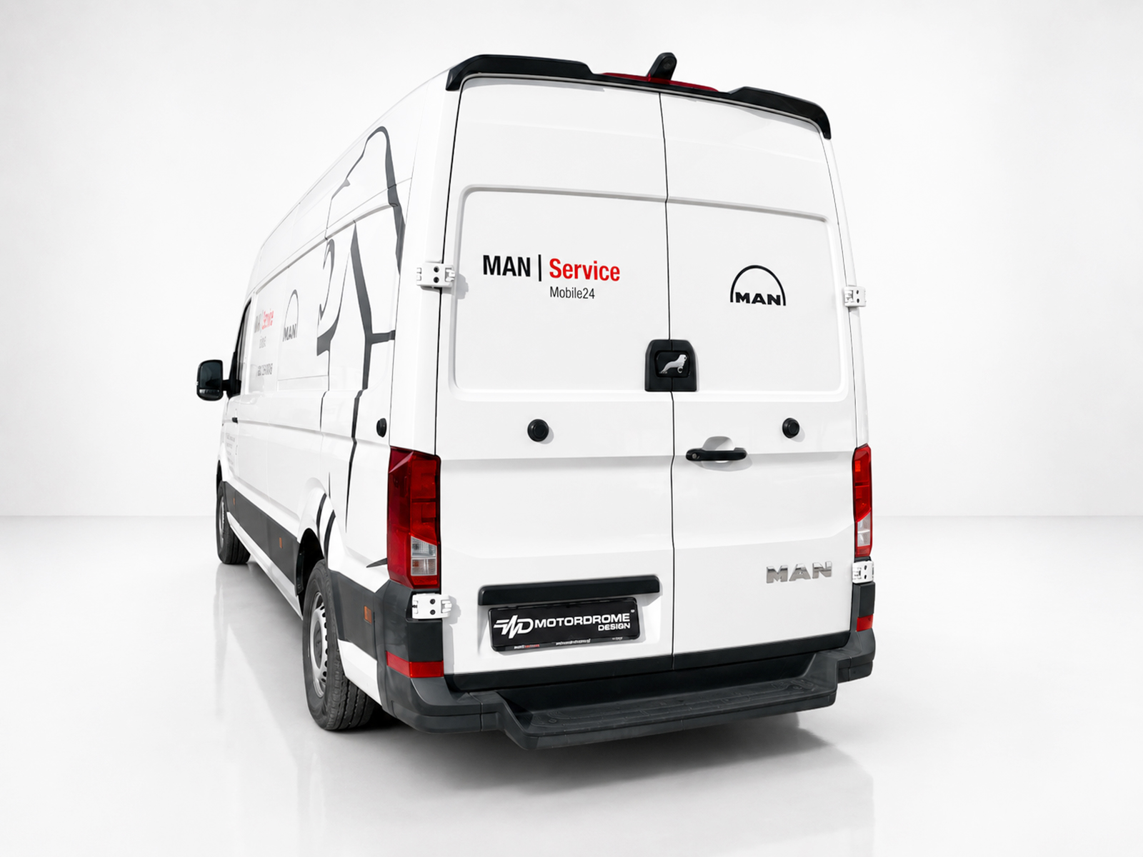 A-561_2jpg - OPSHOLDERS Rear view of a white MAN cargo van with 'MAN Service' branding on the doors and a logo on the right door in a studio setting