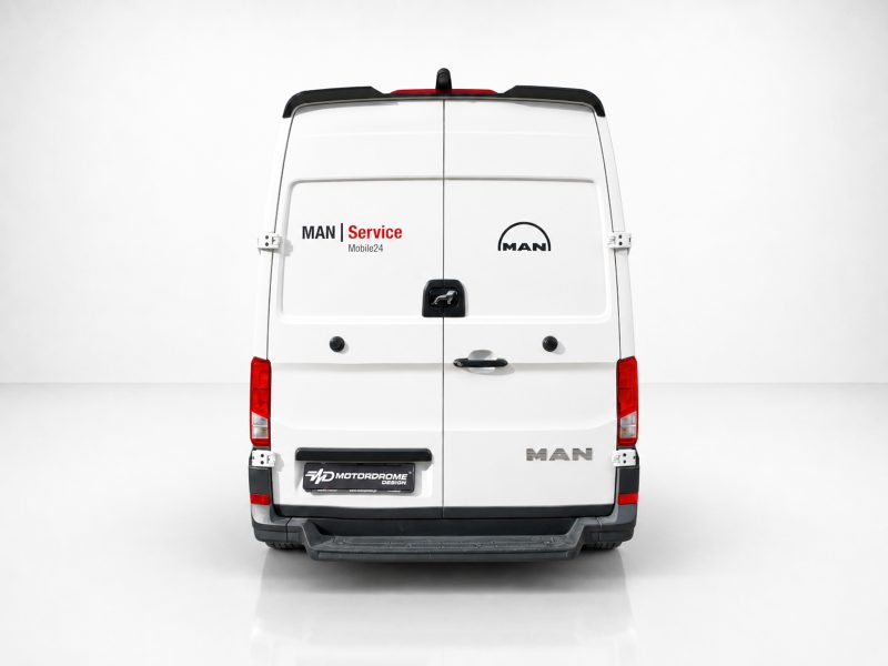 A-561_3jpg - OPSHOLDERS Rear view of a white MAN van with 'MAN Service Mobile24' branding on the left door and the MAN logo on the right.