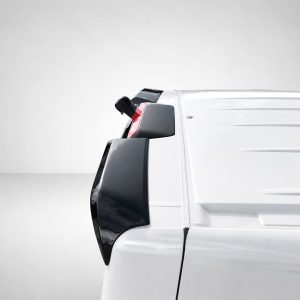 A-561_5jpg - OPSHOLDERS Partial side view of a white cargo van with black trim and mirror, shown against a neutral background