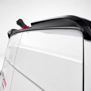 A-561_6jpg - OPSHOLDERS Rear side of a white van showing a black roof spoiler and small antenna on top edge of the cargo area