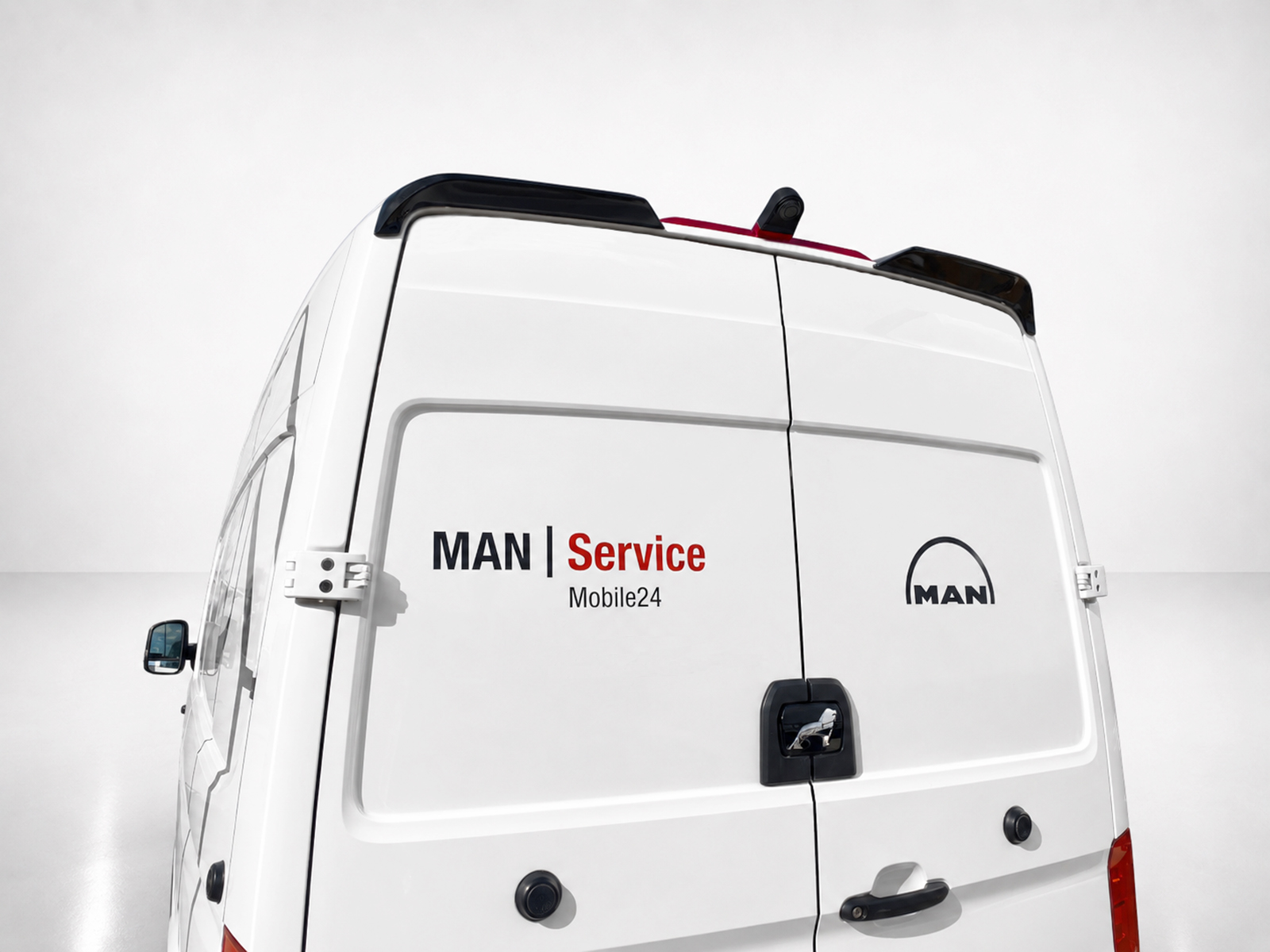 A-563_1jpg - OPSHOLDERS White MAN service van rear with 'MAN Service Mobile24' logo and back doors closed, emergency service branding visible