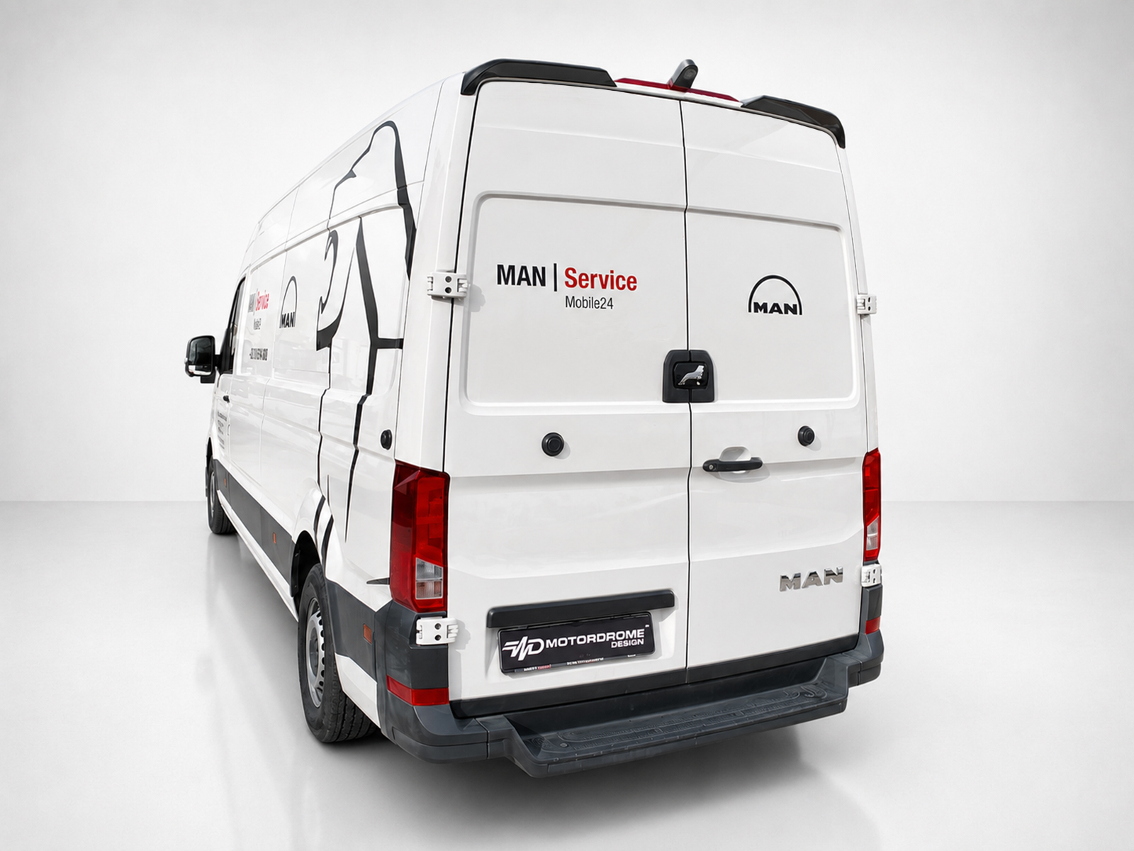A-563_2jpg - OPSHOLDERS White MAN service van shown from rear-left, with 'MAN | Service Mobile24' branding on the back doors and a black rear bumper.