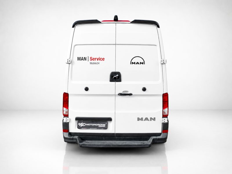 A-563_3jpg - OPSHOLDERS Rear view of a white MAN van with 'MAN Service' branding and 'Mobile24' on the left door, and the MAN logo on the right door.