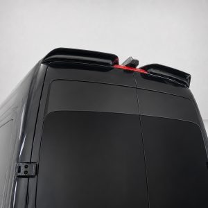 Rear upper section of a black van with roof spoilers and a red third-brake light visible at the top edge.