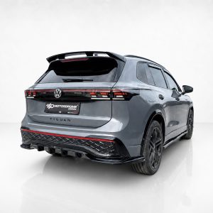 A-565_4jpg - OPSHOLDERS Rear view of a metallic gray Volkswagen Tiguan with a sports body kit and red taillight strip in a studio setting.