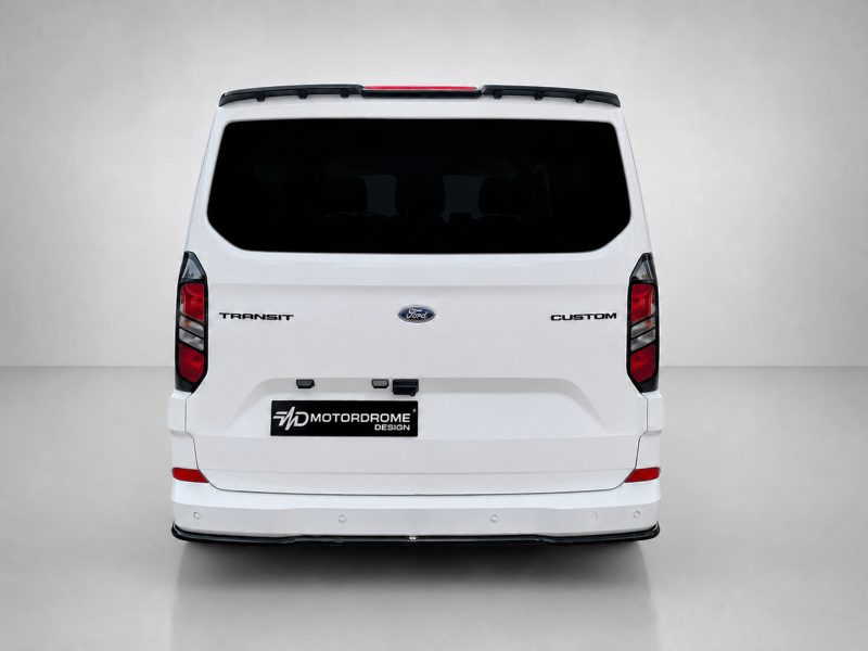 Rear view of a white Ford Transit Custom van with dark rear window and Motordrome Design plate on the bumper