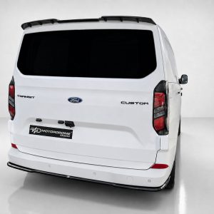 Rear view of a white Ford Transit Custom van with a dark rear window and roof rack on a light studio backdrop.