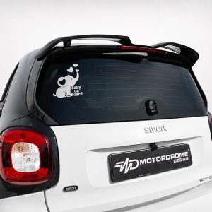 White Smart car rear with a 'Baby on Board' sticker featuring a cute elephant and hearts on the back window