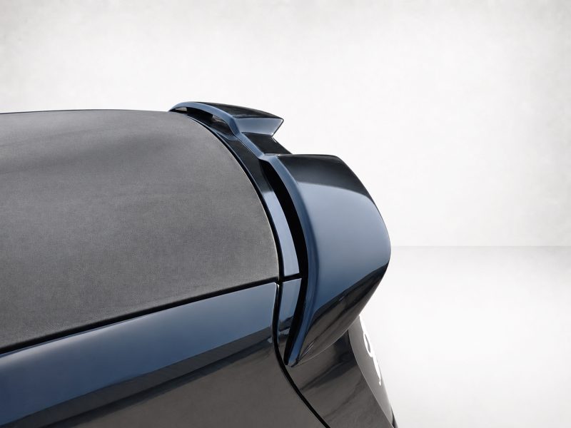 Close-up of a dark blue car trunk with an aerodynamic rear spoiler.
