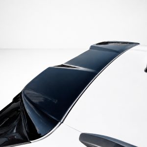 Aerial view of a white car showing a glossy black roof panel and windshield from above in a minimalist setting