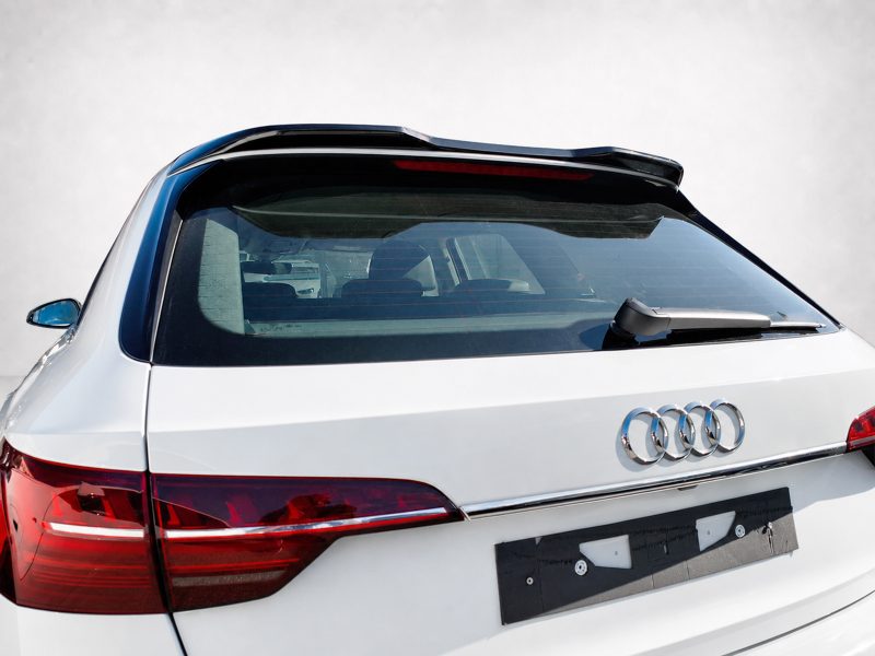 Rear view of a white Audi SUV showing the trunk, rear windshield, wiper, and red taillights with the Audi emblem visible