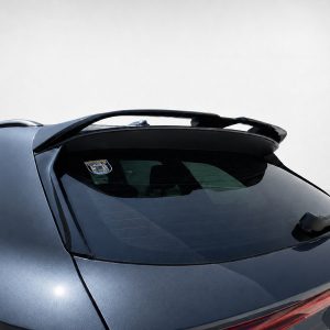 Blue hatchback car rear with a sporty spoiler mounted on the tailgate and a sticker on the rear window