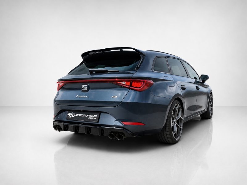Rear three-quarter view of a blue SEAT Leon FR hatchback in a studio setting, showing quad exhausts and sporty stance