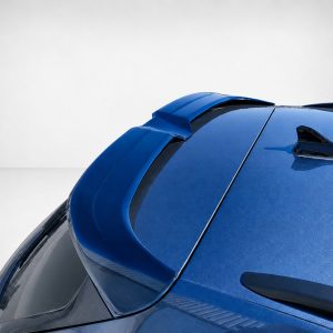 Close-up of a blue car roof showing a shark-fin antenna and rear spoiler at an angle