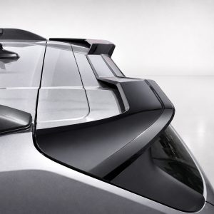 Close-up of a silver car rear with a modern, angular spoiler and rear window.