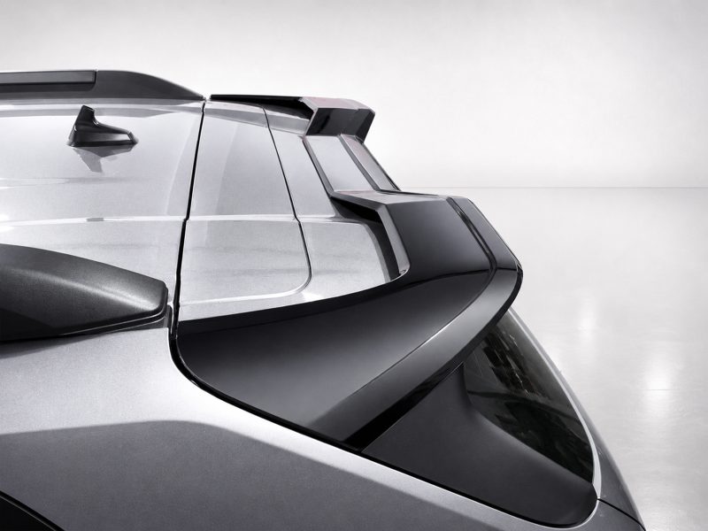 Close-up of a silver car rear with a modern, angular spoiler and rear window.