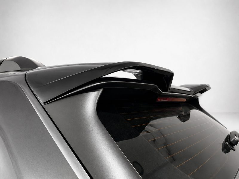 Close-up of a car's rear end featuring a large spoiler on the hatch.