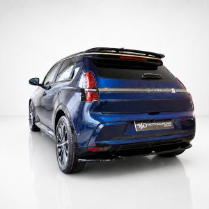 Blue SUV shown from the rear-left in a bright studio, with 'Motordrome' branding on the license plate area