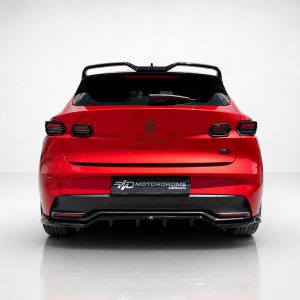 Rear view of a red Renault Clio hatchback with a black spoiler and glossy finish against a light backdrop.