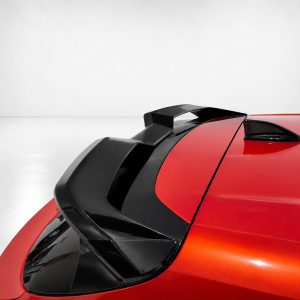Close-up of a red sports car showing a black aerodynamic spoiler and roof details against a light gray background, emphasizing design lines.