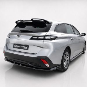 A-574_2jpg - OPSHOLDERS Rear three-quarter view of a silver SUV in a studio, highlighting the tail lights, roof spoiler, and a black rear license plate reading 'MOTORDROME DESIGN'.