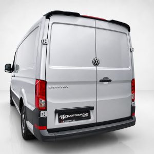 A-575_2jpg - OPSHOLDERS Rear view of a silver Volkswagen Crafter cargo van with rear doors closed and VW emblem visible on the center seam, on a plain background.