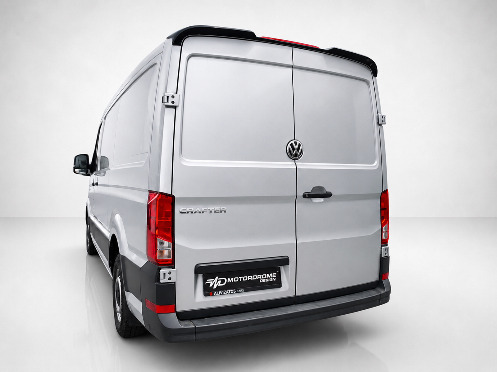 A-575_2jpg - OPSHOLDERS Rear view of a silver Volkswagen Crafter cargo van with rear doors closed and VW emblem visible on the center seam, on a plain background.