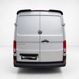 A-575_3jpg - OPSHOLDERS Rear view of a silver Volkswagen Crafter van with twin back doors, VW emblem, and red tail lights in a studio setting.