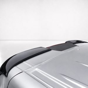 A-575_4jpg - OPSHOLDERS Close-up of the front-right side of a silver car, featuring a dark glass sunroof and glossy hood in a studio setting.