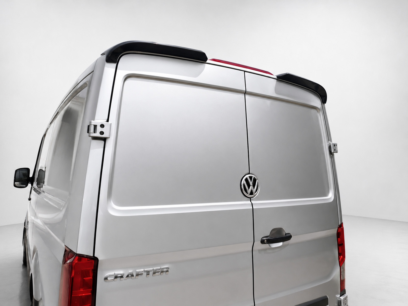 A-576_1jpg - OPSHOLDERS Rear view of a silver Volkswagen Crafter cargo van with double back doors and VW emblem in the center of the doors.