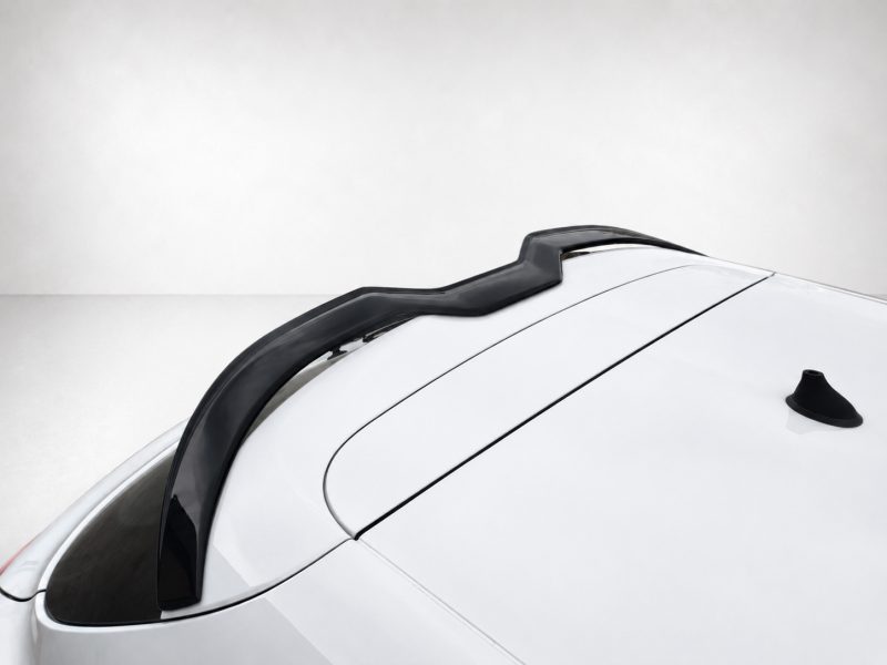 Close-up of a white car roof featuring a black roof rail running along the center of the roof.