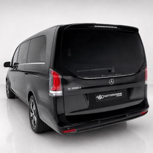 A-578_2jpg - OPSHOLDERS Rear view of a black Mercedes-Benz V 300d van in a white studio setting, showing taillights and rear window.