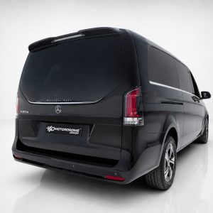A-578_4jpg - OPSHOLDERS Rear-left three-quarter view of a black Mercedes-Benz V300d van in a studio, with tinted windows and Motordome Design plate on the bumper.