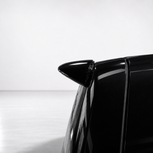 A-578_5png - OPSHOLDERS Close-up of a black car's rear spoiler against a light gray background