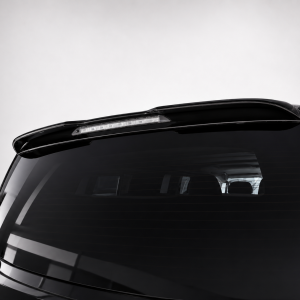 A-578_6png - OPSHOLDERS Rear view of a glossy black car hatch with a slim third‑brake light on the spoiler above the rear window