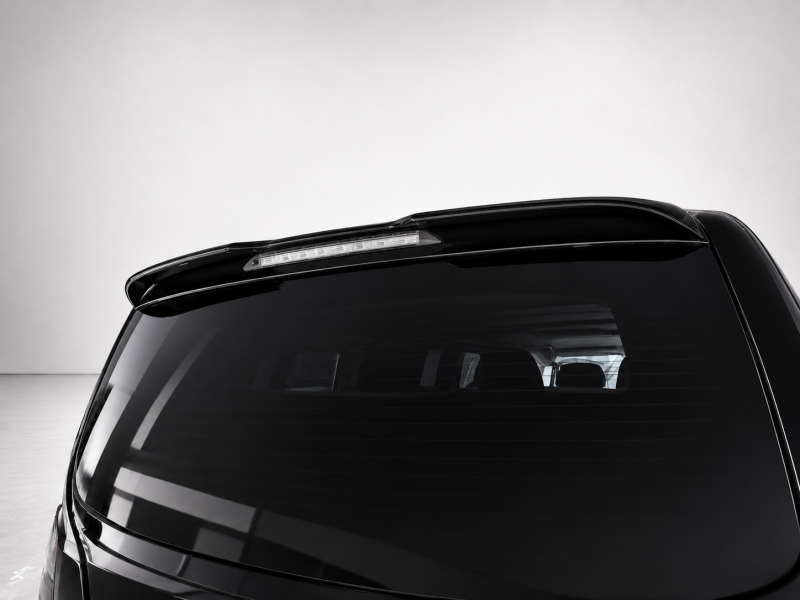 A-578_6png - OPSHOLDERS Rear view of a glossy black car hatch with a slim third‑brake light on the spoiler above the rear window