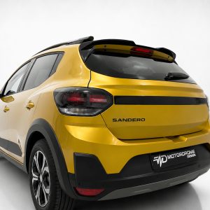 A-579_2jpg - OPSHOLDERS Rear three-quarter view of a bright yellow Sandero SUV in a studio setting, showing black trim and alloy wheels.