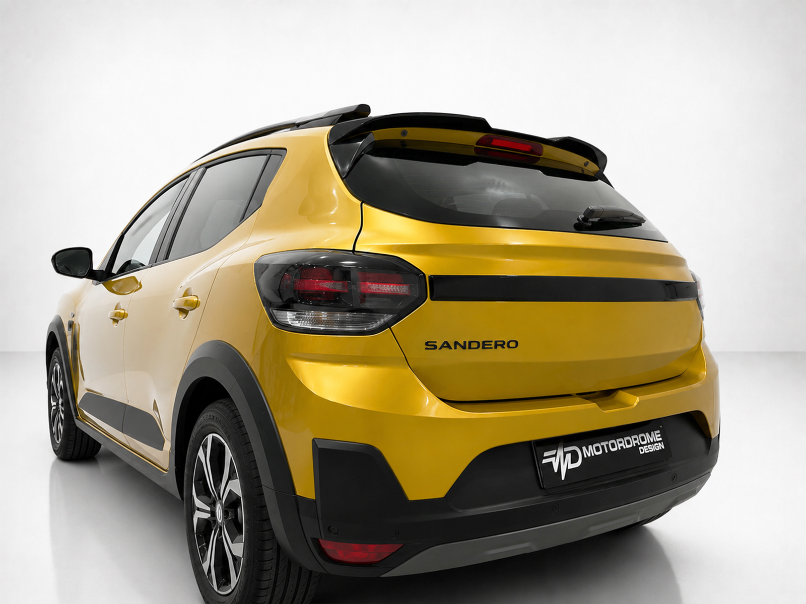 A-579_2jpg - OPSHOLDERS Rear three-quarter view of a bright yellow Sandero SUV in a studio setting, showing black trim and alloy wheels.