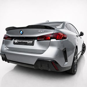 Silver BMW 220 rear view in a studio setting with a Motordrome Design license plate and red taillights
