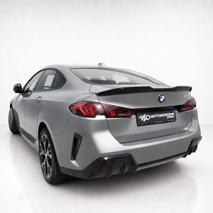 A-581_3jpg - OPSHOLDERS Silver BMW sedan shown from rear-three-quarters with a large black spoiler and MD Motordrome Design license plate area