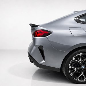 A-581_6jpg - OPSHOLDERS Rear half of a silver BMW with a prominent red taillight, sporty rear bumper, and large black alloy wheel in a studio setting.
