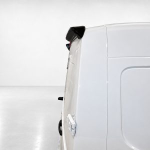 Side view of a white cargo van with a visible rear door and taillight in a bright studio setting.