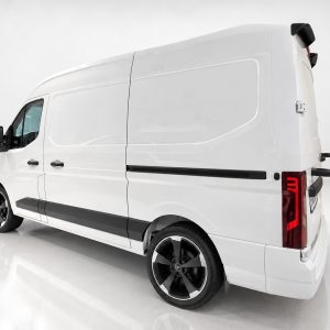 Rear-right view of a white high-roof cargo van, showing its side panel, black trim, and large alloy wheels in a studio setting.